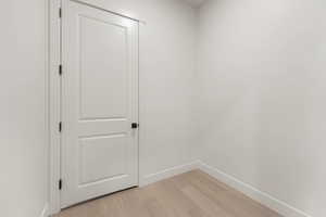 Empty room with light wood finished floors and baseboards