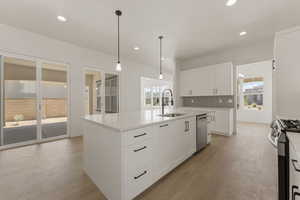 Kitchen featuring backsplash, white cabinetry, decorative light fixtures, light wood-style floors, and recessed lighting