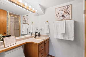 Bathroom featuring a shower stall and vanity