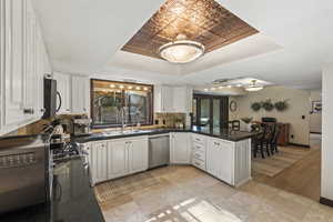Huge Kitchen with a peninsula, white cabinets, and abundant counterspace. Large window with views to the backyard and deck.