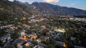Aerial view of property's location featuring a mountainous background and nearby suburban area