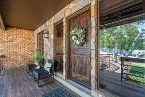 Impressive entry with stunning custom door and large windows with plantation shutters.