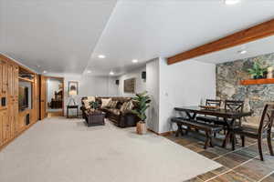 Living area featuring recessed lighting and beamed ceiling