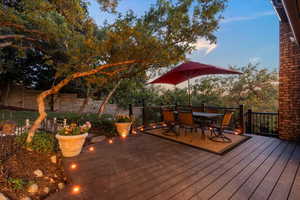 Back of home featuring a Trex deck, pergola and water feature