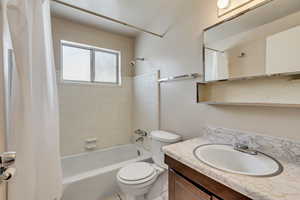 Full bathroom featuring shower / bathtub combination with curtain and vanity