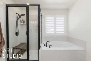 Primary bathroom featuring a garden tub and a marble finish shower