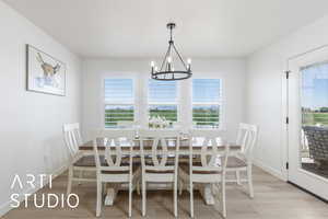 Dining room featuring light wood-type flooring and a chandelier