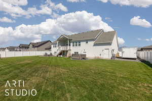 Back of house with a hot tub, a patio area, a fenced backyard, a residential view, and stucco siding