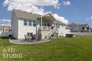 Rear view of property featuring a patio area, a hot tub, stairs, and a fenced backyard