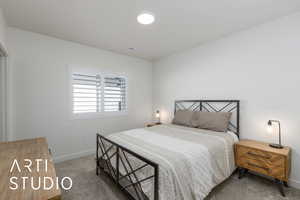 Bedroom with carpet floors and baseboards
