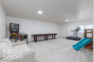 Workout area with light colored carpet and recessed lighting