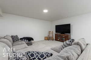 Carpeted living room with baseboards
