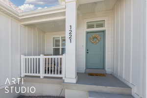 Property entrance featuring board and batten siding and a porch