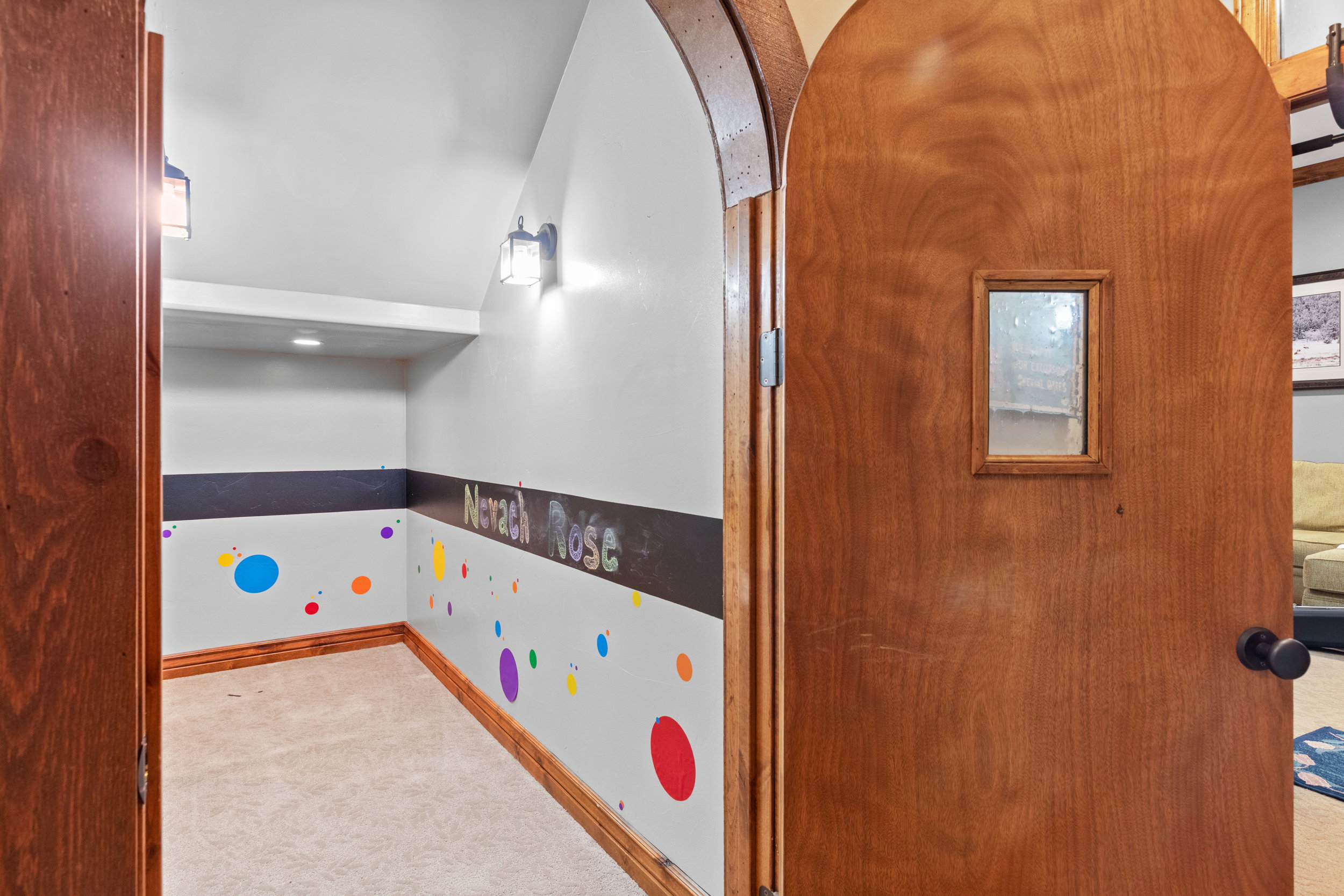Recreation room featuring carpet floors and arched walkways