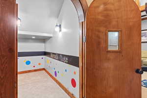 Recreation room featuring carpet floors and arched walkways