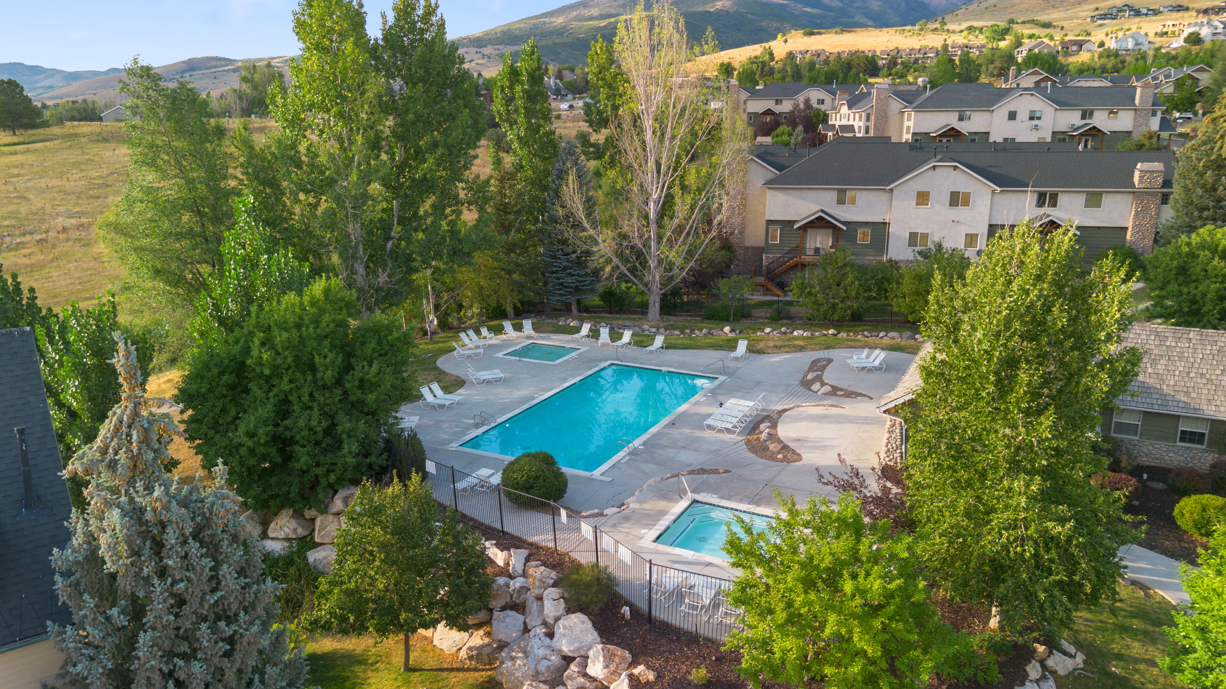 Aerial view of a mountain backdrop and a pool