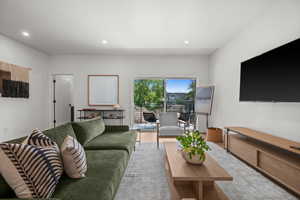 Living room looking towards patio featuring recessed lighting and wood finished floors