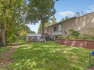 View of grassy yard with a sunroom