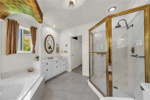 Full bathroom featuring a garden tub, a marble finish shower, double vanity, light tile patterned floors, and ornamental molding