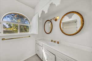 Full bathroom featuring vanity and baseboards