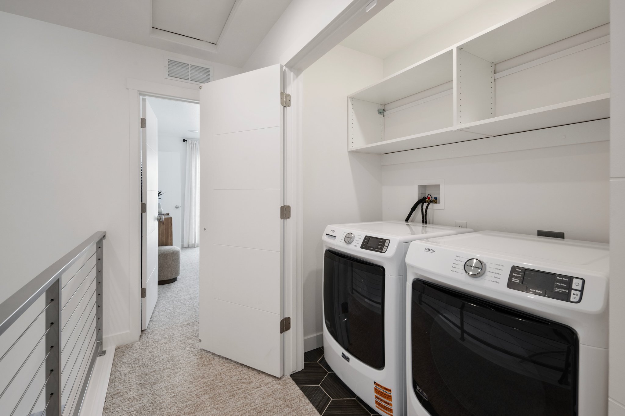 Out of sight but never out of style. This laundry space is as practical as it is polished.