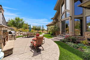 View of patio featuring outdoor dining area and area for grilling