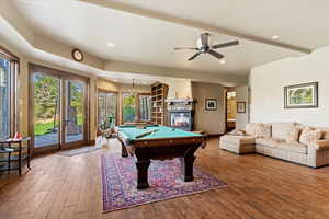 Game room featuring billiards table, recessed lighting, wood finished floors, a stone fireplace, and ceiling fan