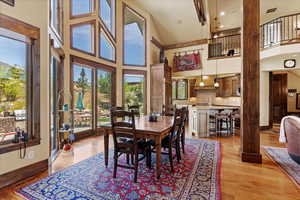 Dining area with floor to ceiling windows for mountain views. Open to the kitchen and living room.