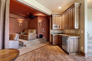 Kitchenette with sink and Sub-Zero refrigerator allows for drinks and snacks while watching a movie or playing pool.
