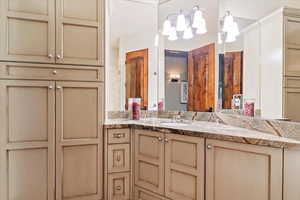 3/4 bathroom with custom vanity cabinetry and granite counter tops, large tiled shower.