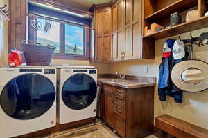 Large laundry room with sink and storage. Located right inside from garage for coats and shoes.
