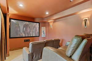 Theater Room with new HD projector, Large screen, elevated leather seating, electric velvet curtain for darkness and dimable wall lighting.
