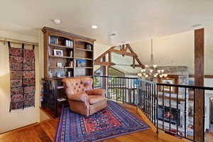 Reading nook overlooking main level living room. Custom floor to ceiling bookshelves. Views of mountain from the large windows.