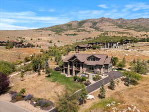 Aerial view of property and surrounding area featuring a mountainous background