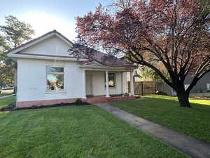 View of front of home with brick siding and a deck