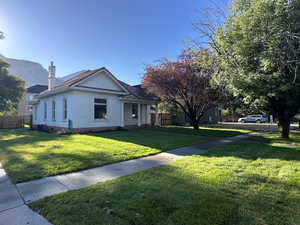 View of front facade with a porch and a chimney