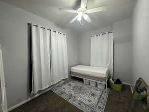 Bedroom featuring ceiling fan and carpet flooring