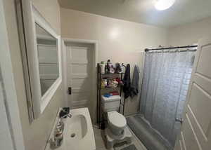 Full bathroom featuring light tile patterned flooring, a stall shower, and vanity