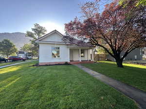 View of front of home featuring covered porch, a mountain view, and brick siding