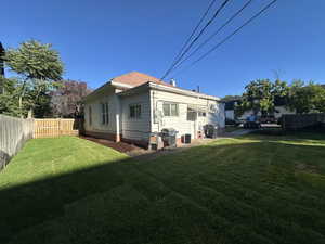 Rear view of property featuring a fenced backyard and a patio area