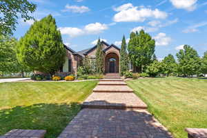 View of front facade with brick siding and a front yard