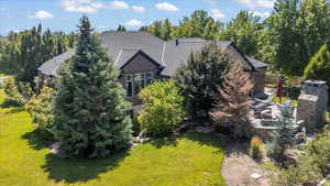 View of subject property with a tree filled landscape