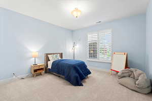 Carpeted bedroom with baseboards