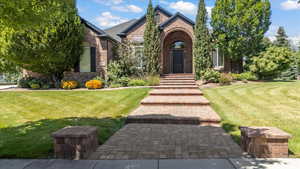 View of front of house with brick siding and a front yard