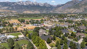 Aerial overview of property's location featuring a mountainous background and nearby suburban area