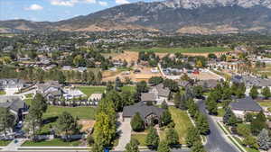 Aerial view of property's location featuring nearby suburban area and a mountainous background