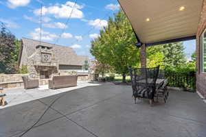 View of patio / terrace featuring outdoor dining area and an outdoor living space with a fireplace