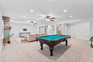 Game room featuring billiards table, light colored carpet, ceiling fan, recessed lighting, and a fireplace