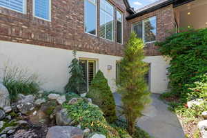 Property entrance with brick siding and stucco siding