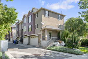 View of front of home featuring mature landscaping